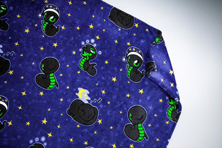 Razer Sneki Snek Fleece Blanket spread out to showcase Sneki Snek designs on blanket